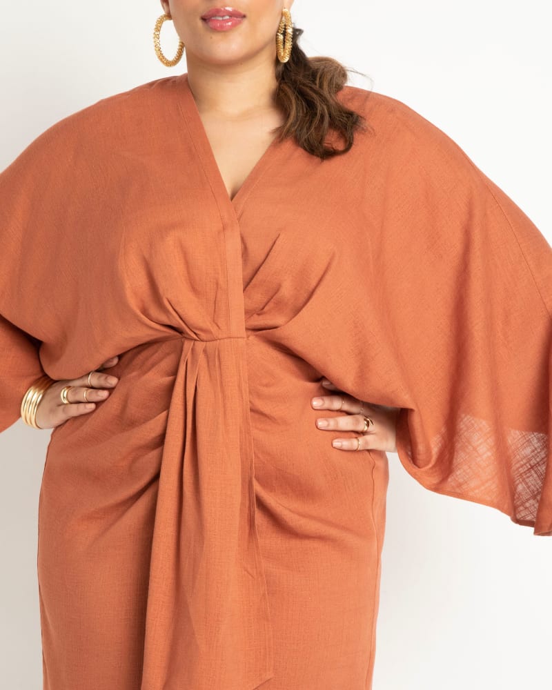 Side of a model wearing a size 24 Draped Linen Dress in Chutney by ELOQUII. | dia_product_style_image_id:295435